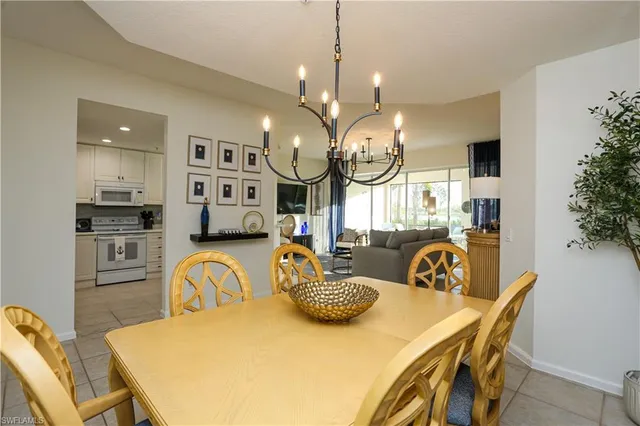 a view of a dining room with furniture and a chandelier
