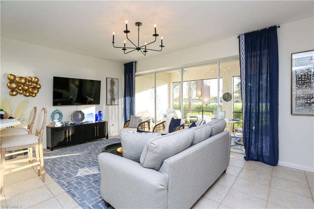 3930 Deer Crossing Court, Unit 3103 Naples, FL 34114 - Photo 35 of 50 a living room with furniture and a flat screen tv