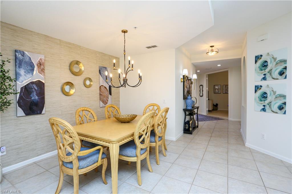 3930 Deer Crossing Court, Unit 3103 Naples, FL 34114 - Photo 37 of 50 a view of a dining room with furniture and chandelier