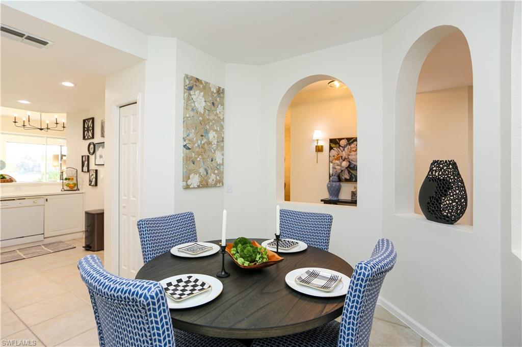 3930 Deer Crossing Court, Unit 3103 Naples, FL 34114 - Photo 41 of 50 a view of a dining room with furniture and wooden floor