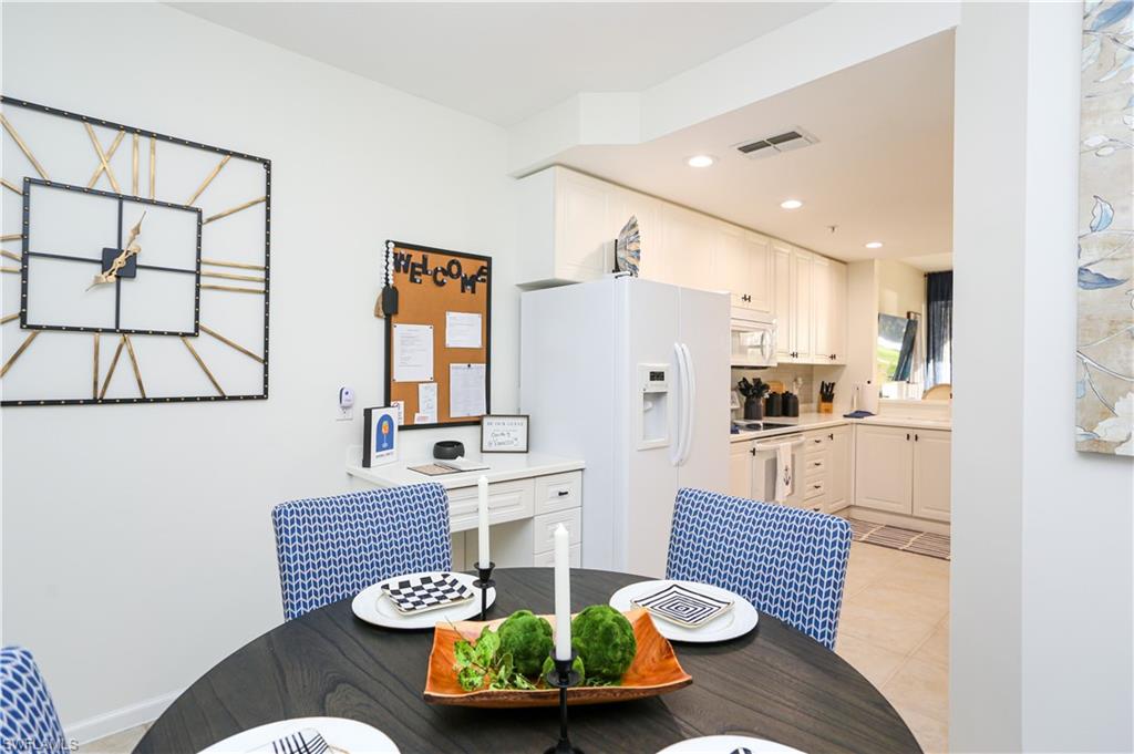 3930 Deer Crossing Court, Unit 3103 Naples, FL 34114 - Photo 42 of 50 a living room with furniture and a table