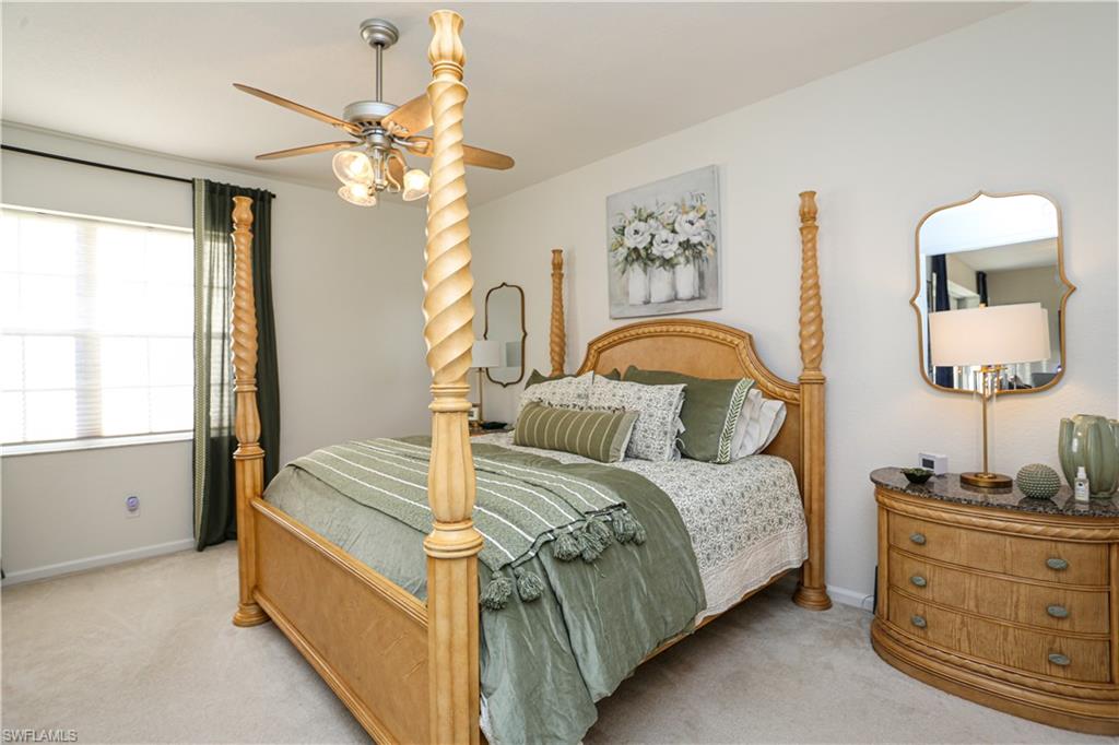 3930 Deer Crossing Court, Unit 3103 Naples, FL 34114 - Photo 43 of 50 a bedroom with a bed and a dresser