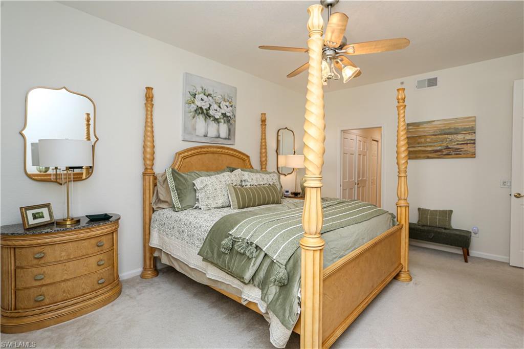 3930 Deer Crossing Court, Unit 3103 Naples, FL 34114 - Photo 44 of 50 a bed room with a bed and a chandelier