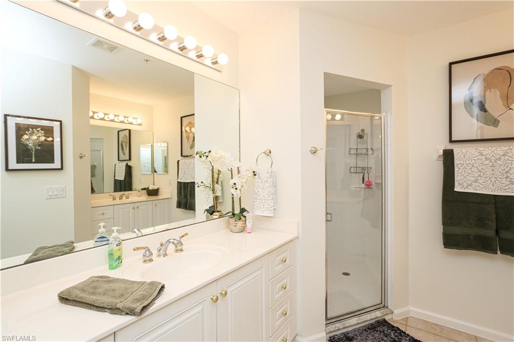 3930 Deer Crossing Court, Unit 3103 Naples, FL 34114 - Photo 48 of 50 a bathroom with a sink double vanity and a mirror
