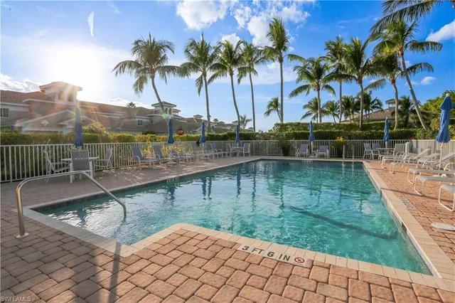 a view of a swimming pool with a table and chairs