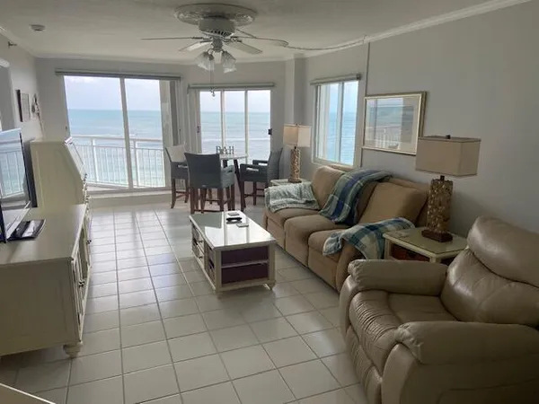 a living room with furniture and a floor to ceiling window
