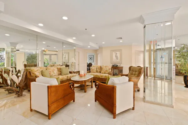 a living room with lots of furniture and a glass door