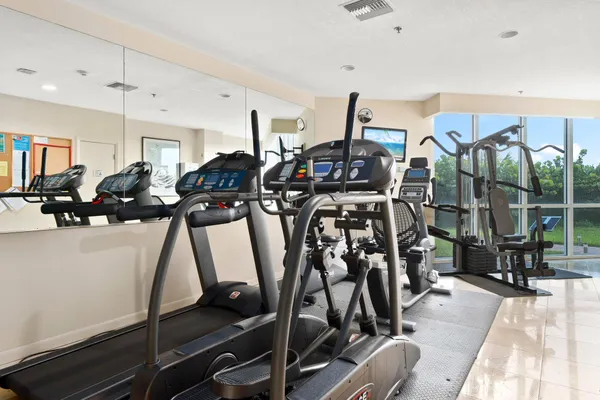 a livingroom with lots of gym equipment