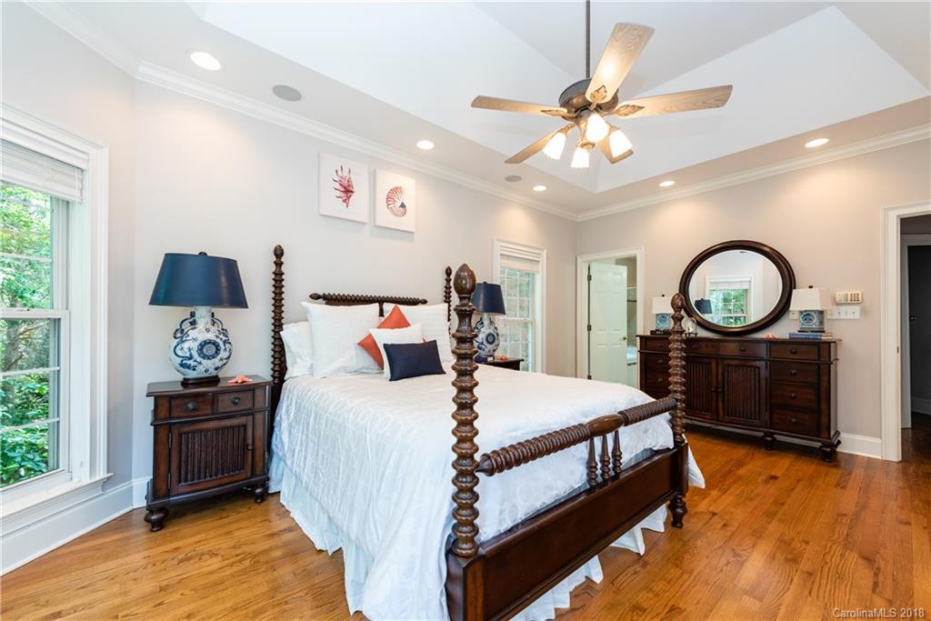 904 Ashford Way, Unit 2 Fort Mill, SC 29708 - Photo 13 of 24 a bedroom with a bed and a chandelier