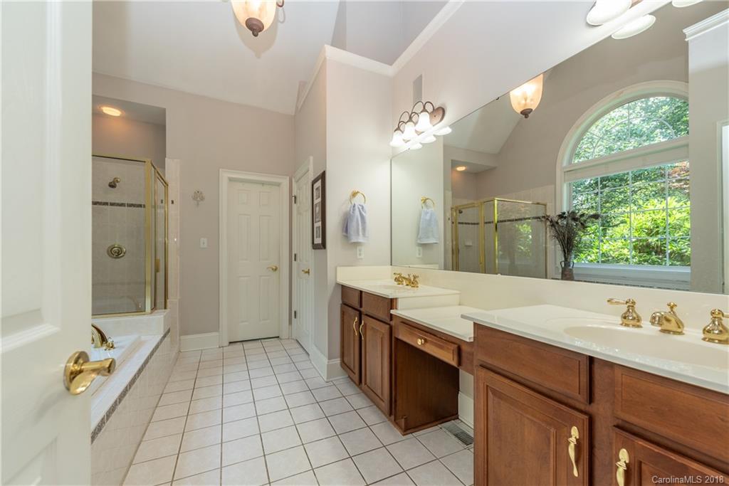 904 Ashford Way, Unit 2 Fort Mill, SC 29708 - Photo 14 of 24 a spacious bathroom with a granite countertop sink a mirror a bathtub and shower