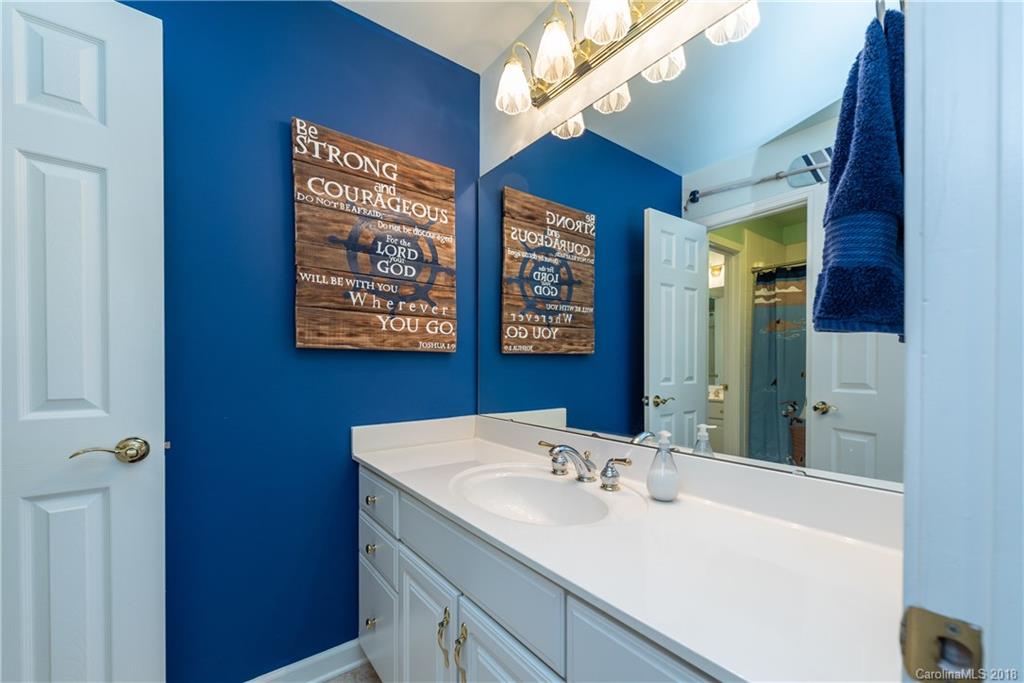 904 Ashford Way, Unit 2 Fort Mill, SC 29708 - Photo 16 of 24 a bathroom with a sink a large mirror and a shower