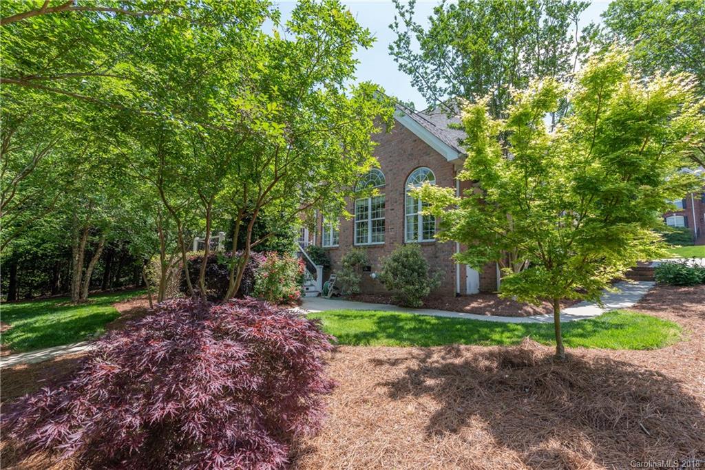 904 Ashford Way, Unit 2 Fort Mill, SC 29708 - Photo 22 of 24 a front view of a house with a garden and trees