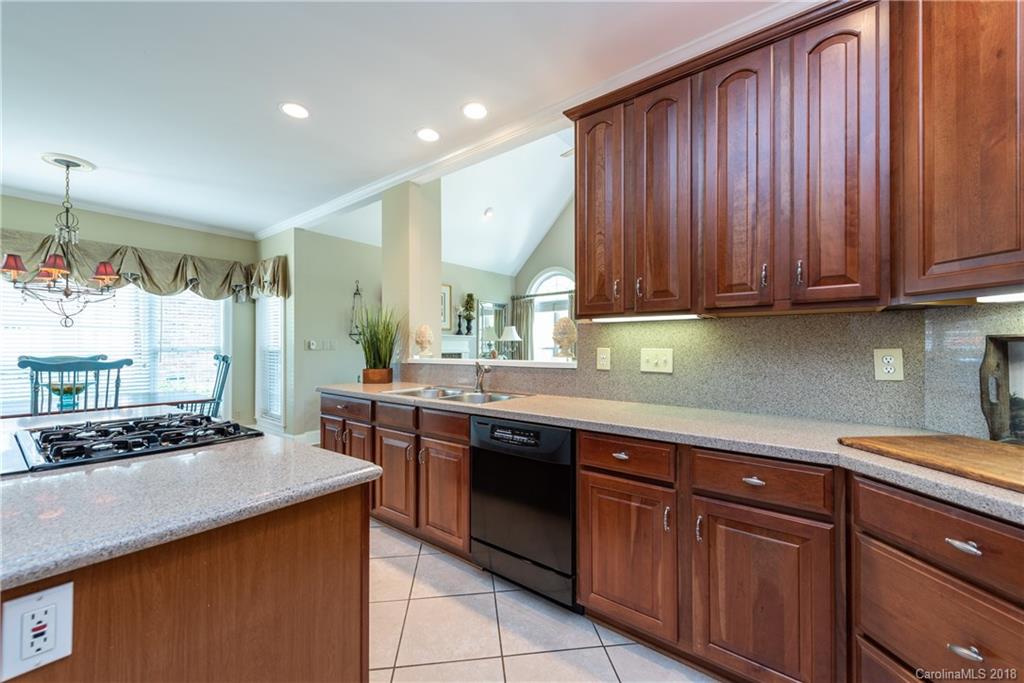 904 Ashford Way, Unit 2 Fort Mill, SC 29708 - Photo 9 of 24 a kitchen with stainless steel appliances granite countertop wooden cabinets a sink and a stove