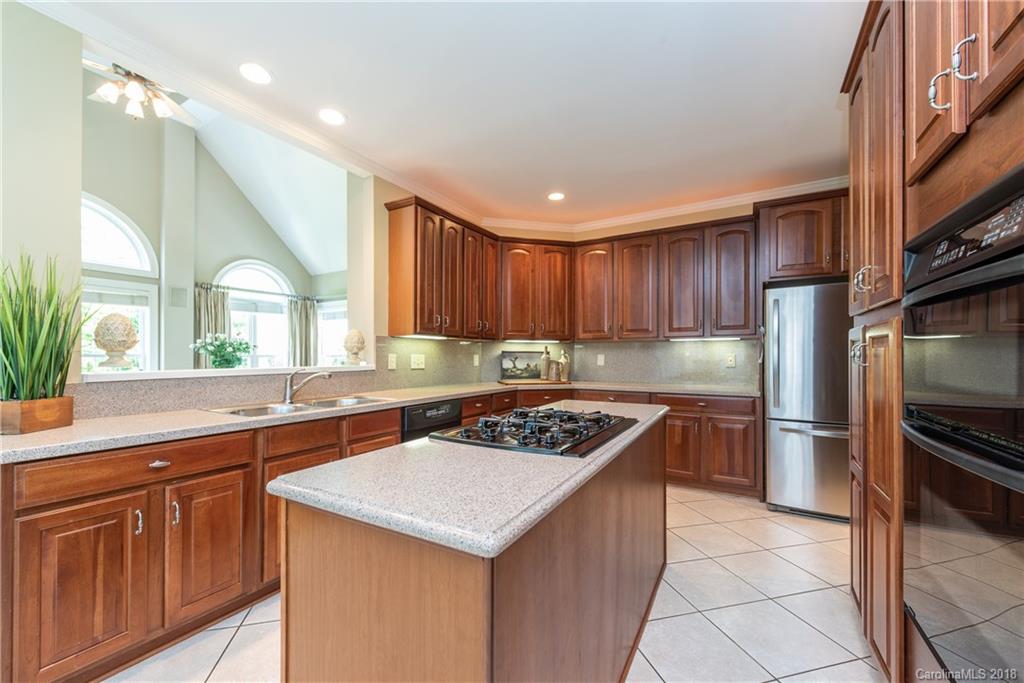 904 Ashford Way, Unit 2 Fort Mill, SC 29708 - Photo 10 of 24 a kitchen with a stove a sink a refrigerator and wooden cabinets