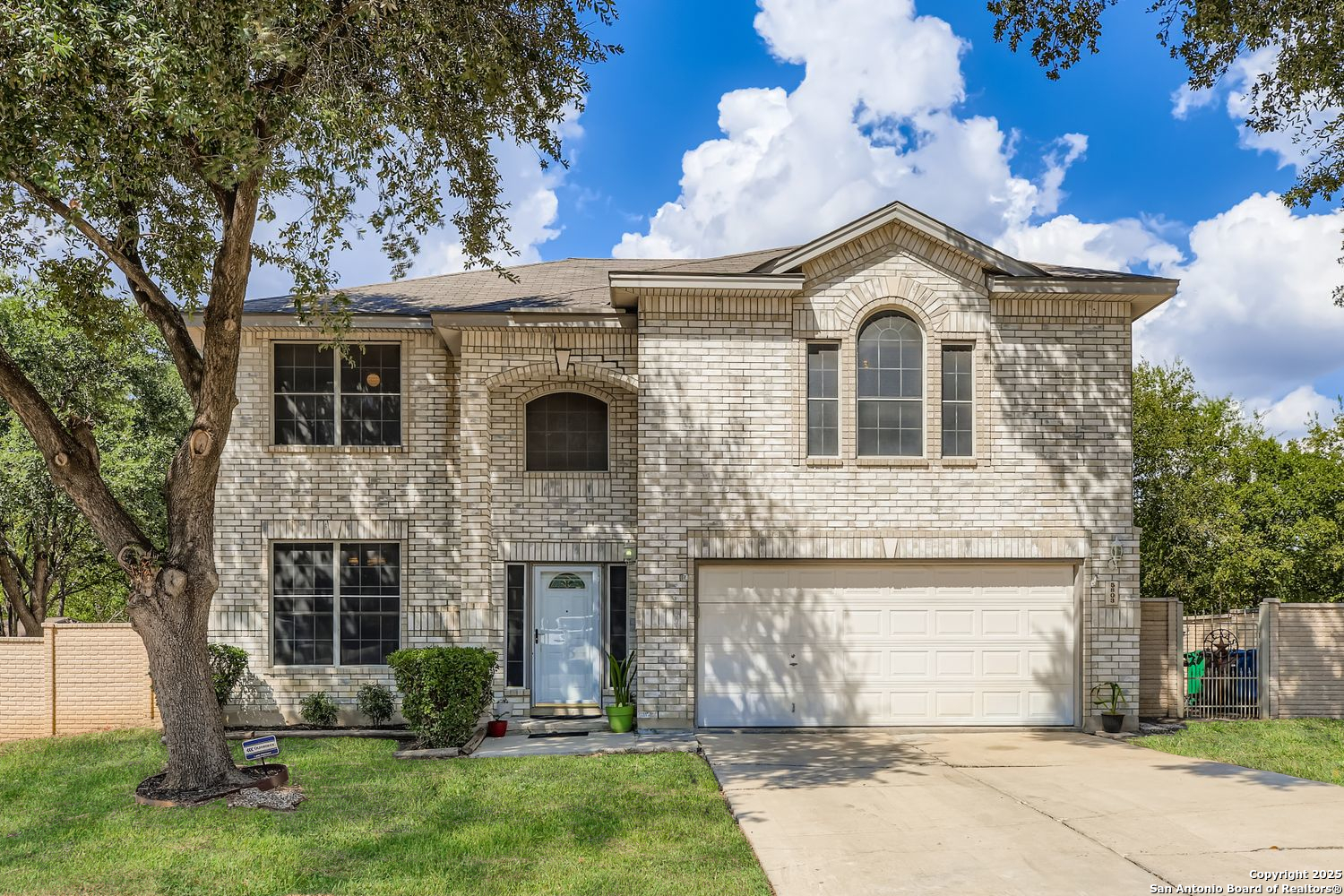 5803 Spring Pebble San Antonio, TX 78247 - Photo 1 of 27 a view of a brick house with a large windows and a large tree