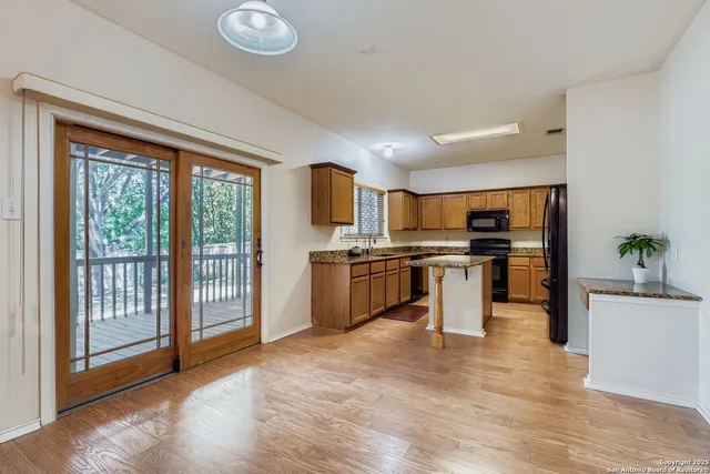a kitchen with stainless steel appliances a stove top oven and a refrigerator