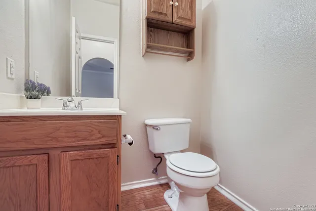a bathroom with a sink toilet and mirror