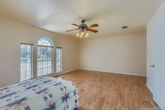 a bedroom with a large bed and a chandelier
