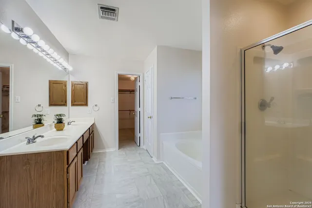 a bathroom with a tub sink and mirror