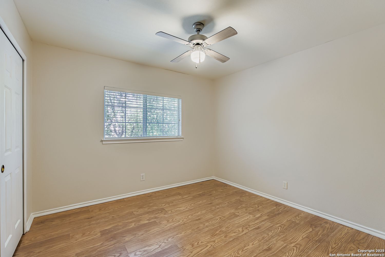 5803 Spring Pebble San Antonio, TX 78247 - Photo 21 of 27 an empty room with wooden floor and windows