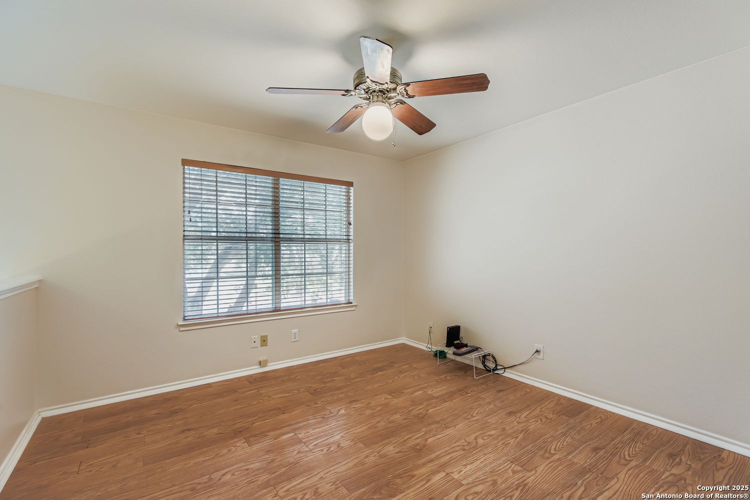 5803 Spring Pebble San Antonio, TX 78247 - Photo 22 of 27 an empty room with a window and a ceiling fan