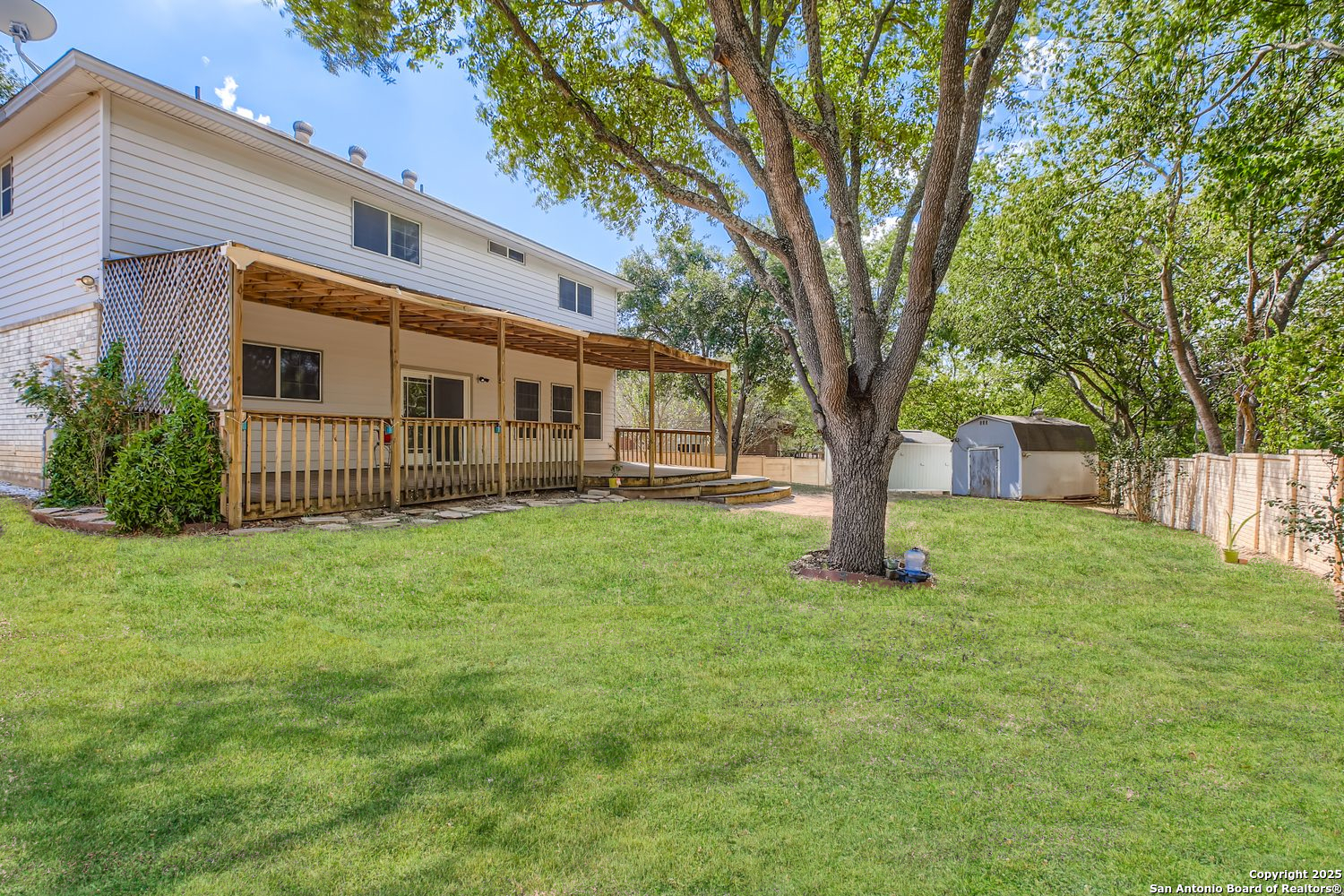 5803 Spring Pebble San Antonio, TX 78247 - Photo 25 of 27 a front view of a house with a garden