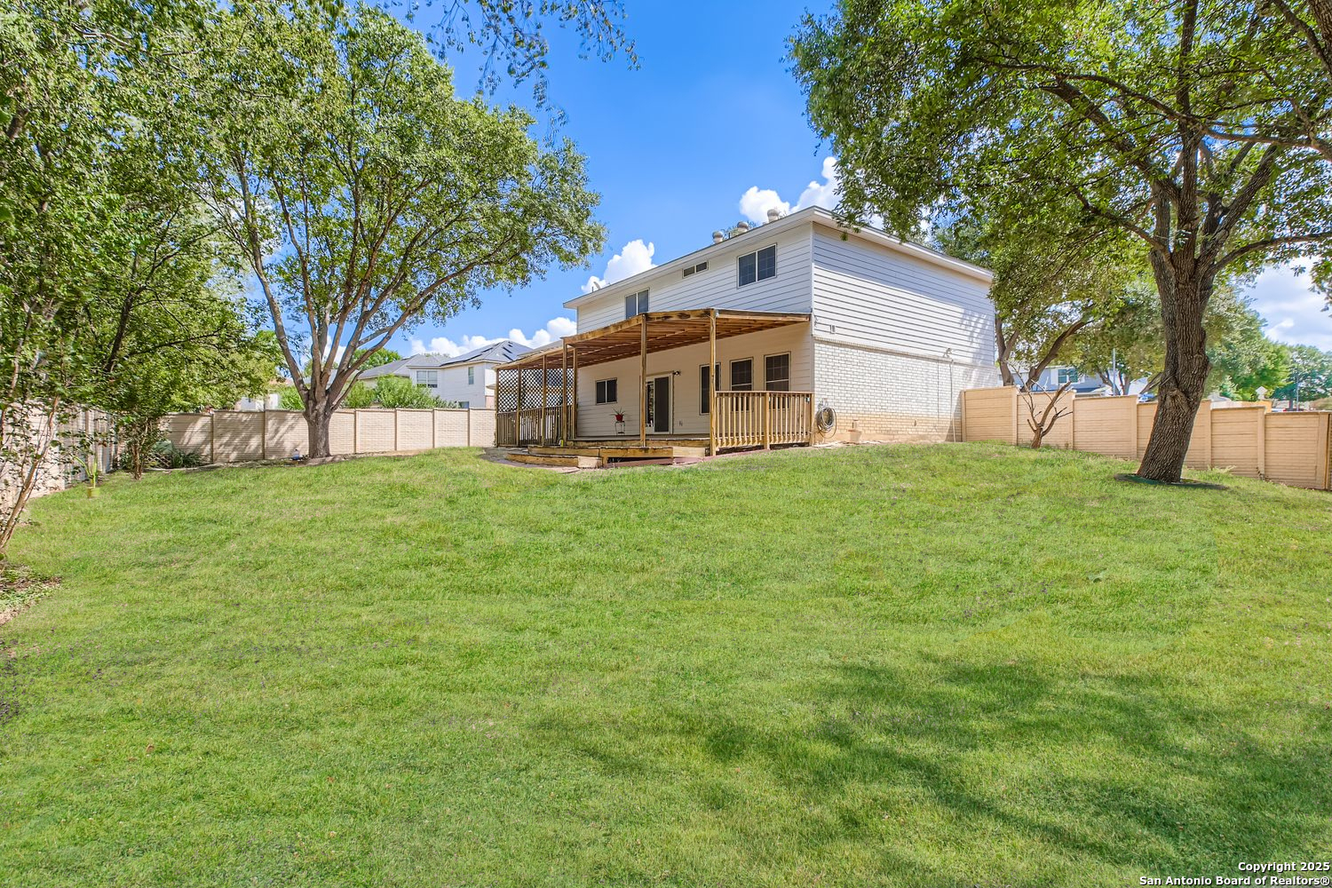 5803 Spring Pebble San Antonio, TX 78247 - Photo 26 of 27 a view of a house with a big yard and large trees