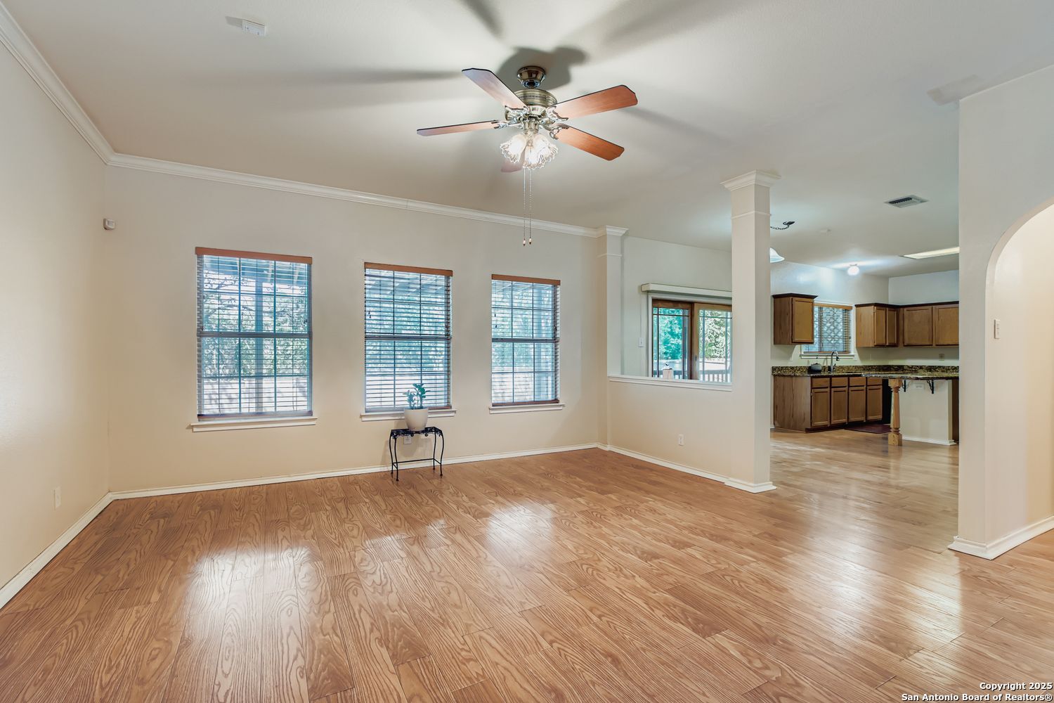 5803 Spring Pebble San Antonio, TX 78247 - Photo 7 of 27 a view of an empty room with window and wooden floor