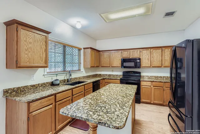 a kitchen with a stove a sink and a refrigerator