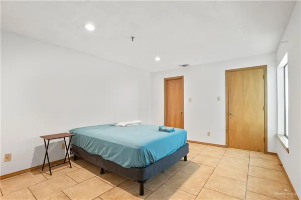 a bedroom with a bed and a table in it