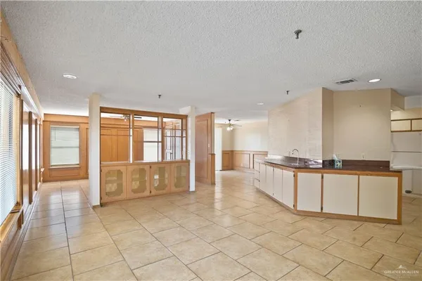 a large white kitchen with a large window