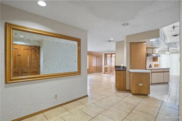 a view of a kitchen with a refrigerator and a stove