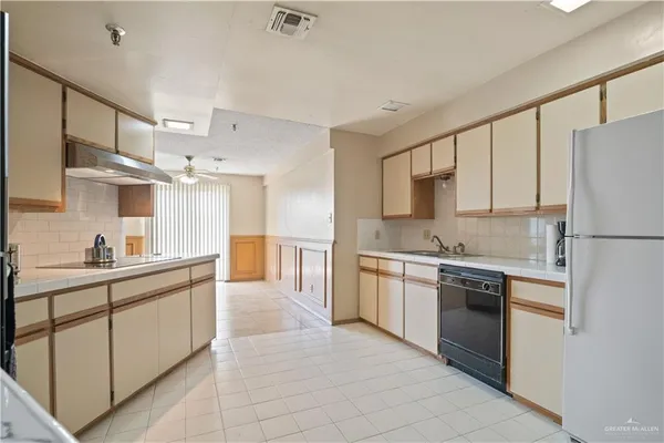 a large kitchen with cabinets stainless steel appliances and a counter space