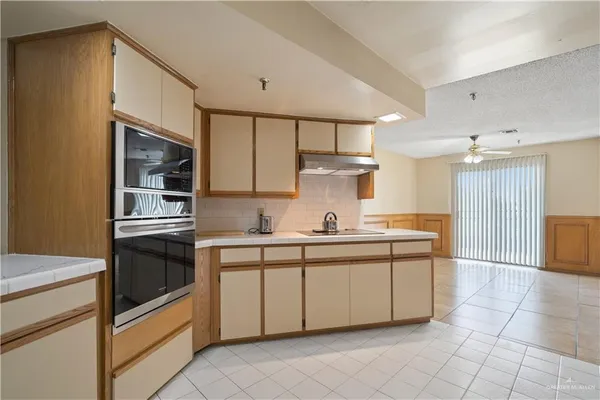 a kitchen with stainless steel appliances a sink and a refrigerator