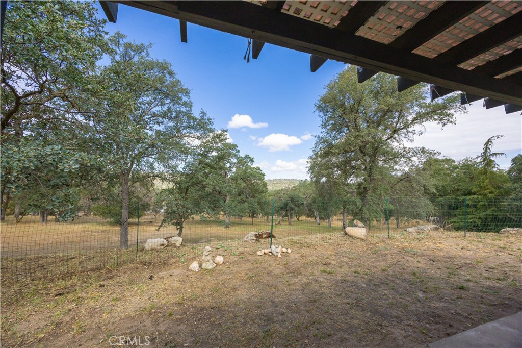 30142 Revis Road Coarsegold, CA 93614 - Photo 31 of 43 a view of a field with trees in the background