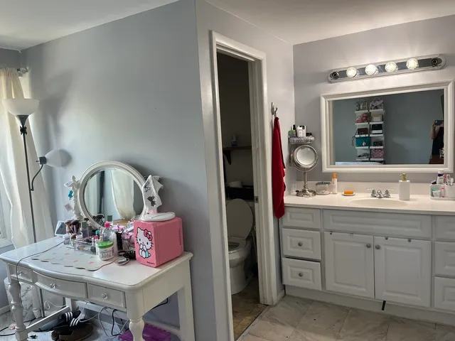a bathroom with a double vanity sink and a mirror