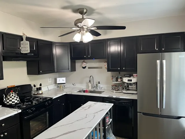 a kitchen with stainless steel appliances a sink stove and refrigerator