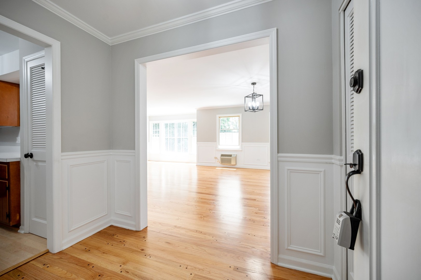1982 Cherry Lane, Unit 15B Northbrook, IL 60062 - Photo 3 of 11 a view of a hallway with wooden floor and a livingroom