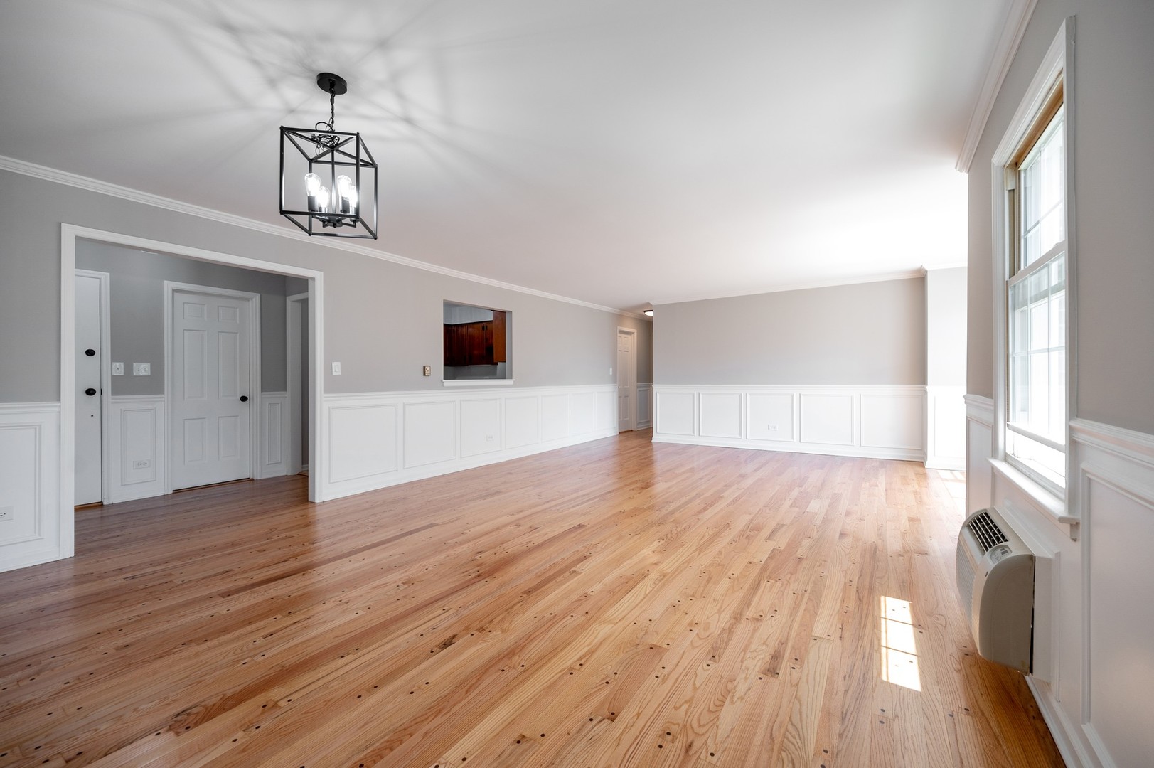 1982 Cherry Lane, Unit 15B Northbrook, IL 60062 - Photo 4 of 11 a view of empty room with wooden floor and window