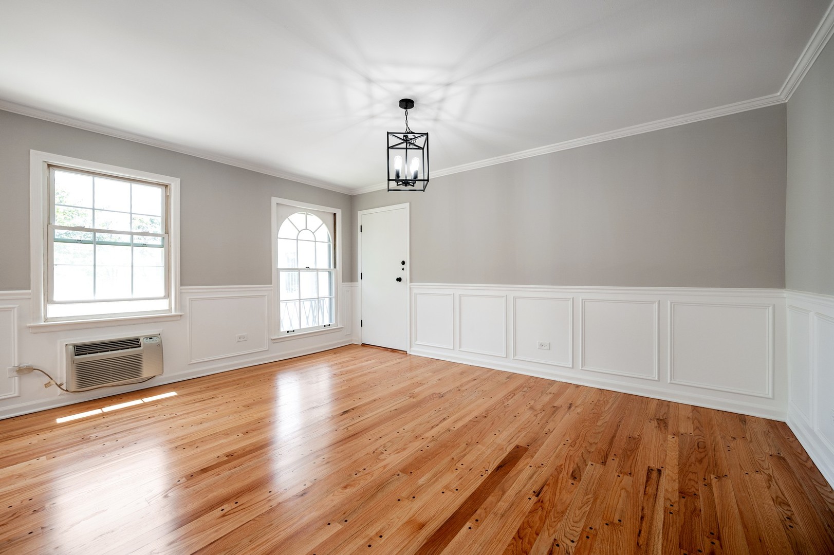 1982 Cherry Lane, Unit 15B Northbrook, IL 60062 - Photo 6 of 11 a view of an empty room with wooden floor and a window