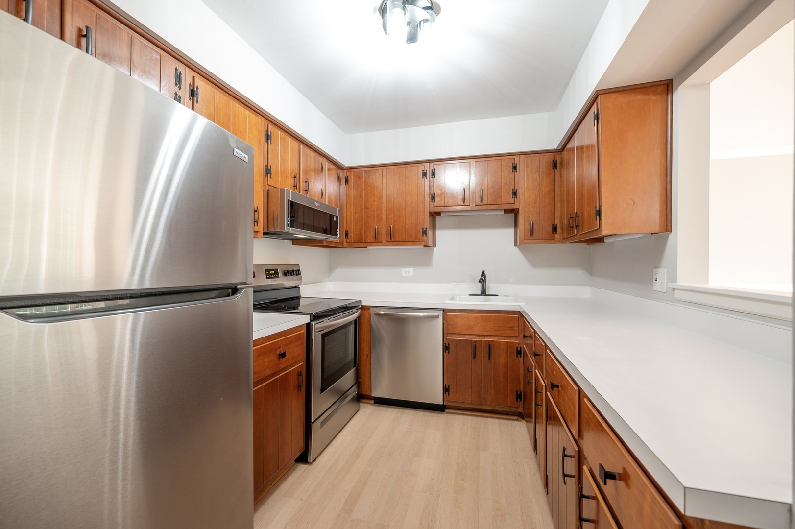 1982 Cherry Lane, Unit 15B Northbrook, IL 60062 - Photo 8 of 11 a kitchen with stainless steel appliances a refrigerator sink and cabinets