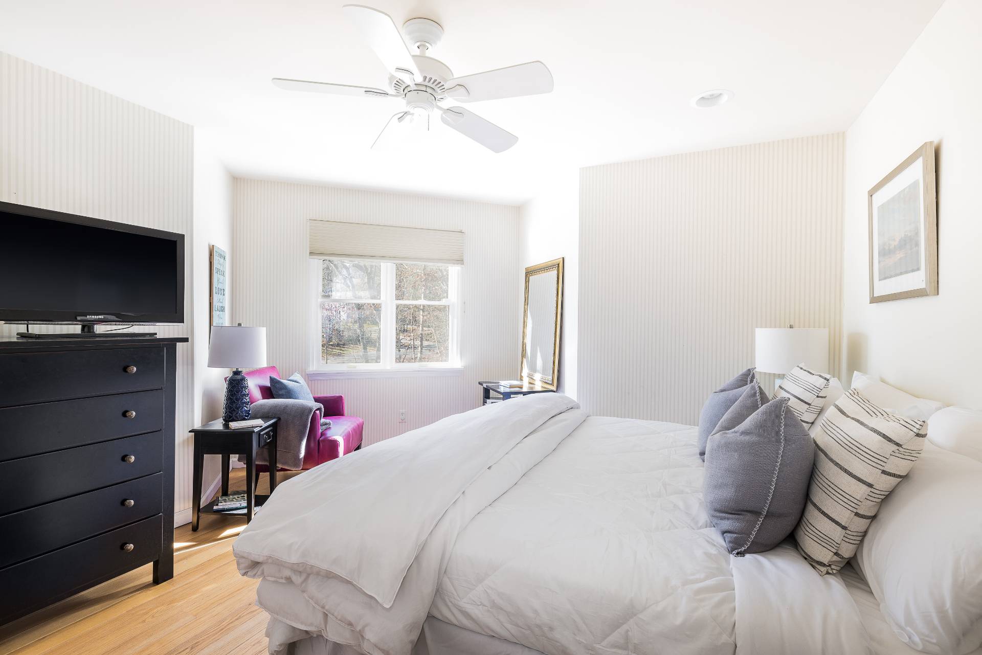 27 Ocean Parkway East Hampton, NY 11937 - Photo 14 of 21 a bedroom with a bed and a flat tv screen on dresser