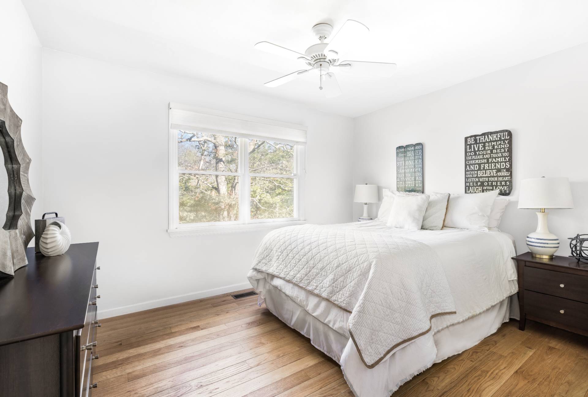 27 Ocean Parkway East Hampton, NY 11937 - Photo 15 of 21 a bedroom with a large bed and a chandelier