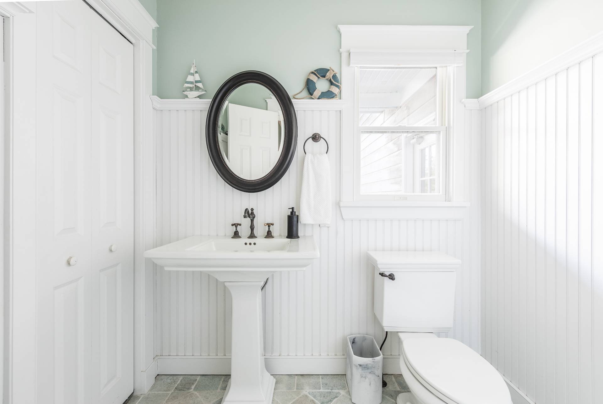 27 Ocean Parkway East Hampton, NY 11937 - Photo 16 of 21 a bathroom with a toilet a sink and a mirror