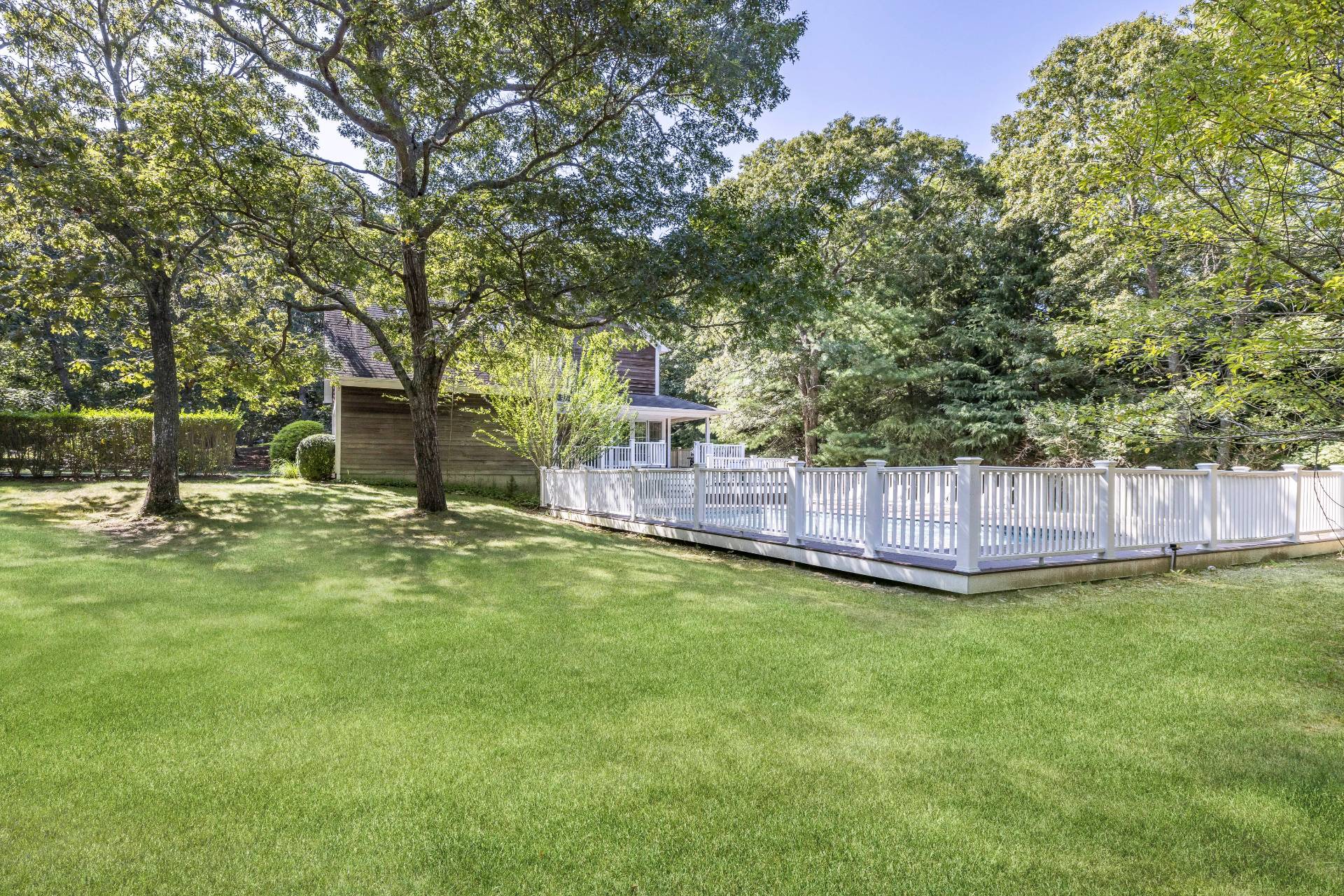 27 Ocean Parkway East Hampton, NY 11937 - Photo 20 of 21 a view of a yard with a house and a large tree