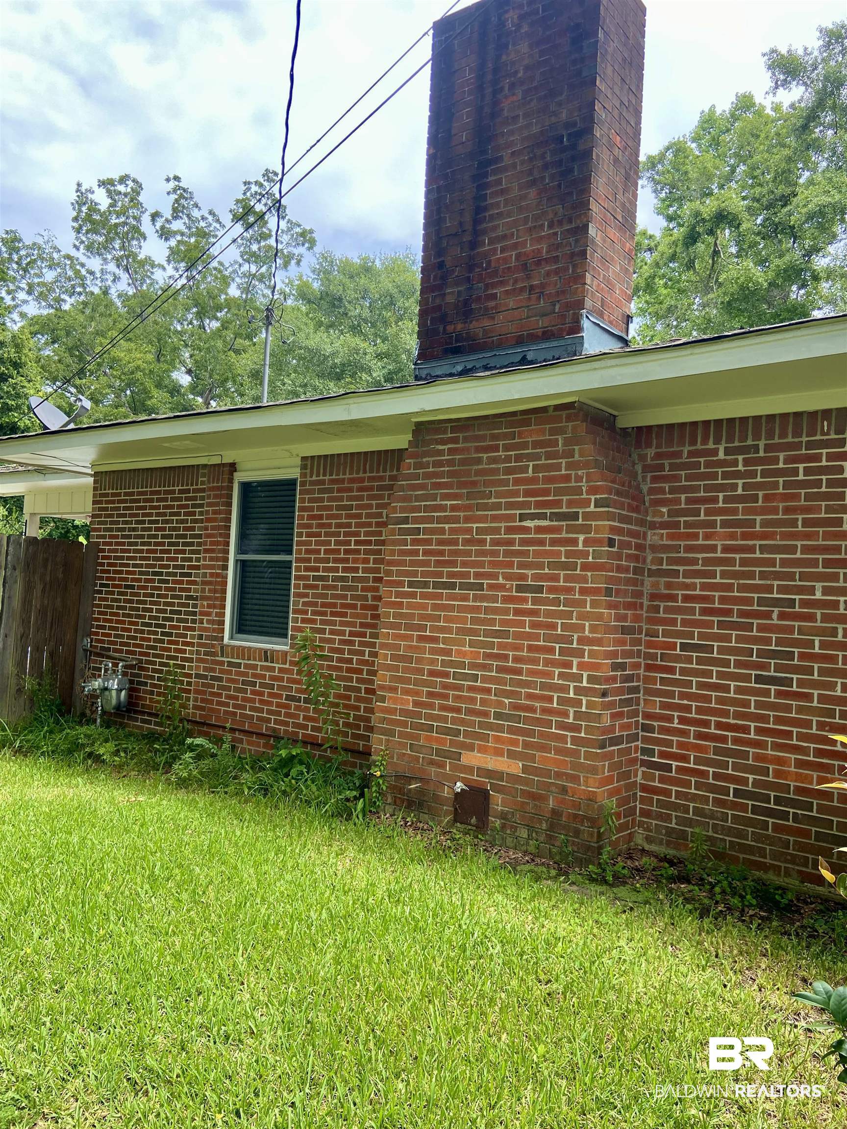 102 Ashley Street Evergreen, AL 36401 - Photo 22 of 26 View of property exterior with a lawn