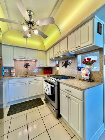 a kitchen with stainless steel appliances granite countertop a sink and cabinets