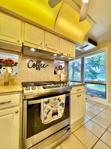 a stove top oven sitting inside of a kitchen