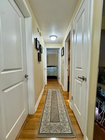 a view of hallway with wooden floor