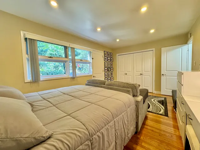 a spacious bedroom with a bed and a large window